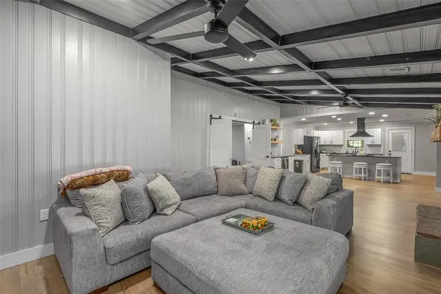 a living room with furniture and a chandelier