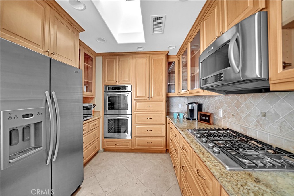 33631 Marlinspike Drive Dana Point, CA 92629 - Photo 12 of 39 a kitchen with stainless steel appliances granite countertop a stove a refrigerator and a cabinets
