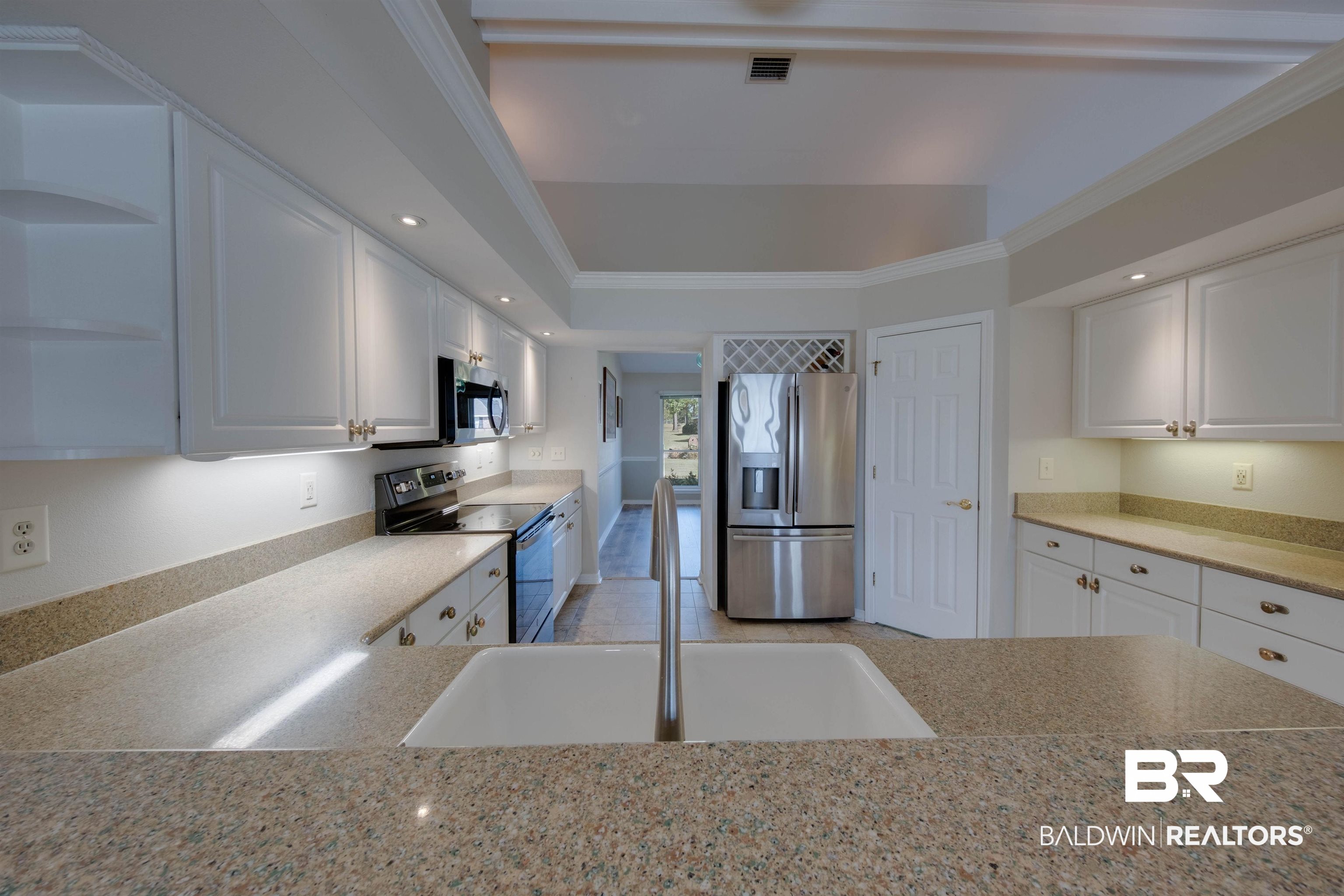 9462 Lakeview Drive Foley, AL 36535 - Photo 17 of 50 Kitchen with white cabinetry, appliances with stainless steel finishes, ornamental molding, and sink
