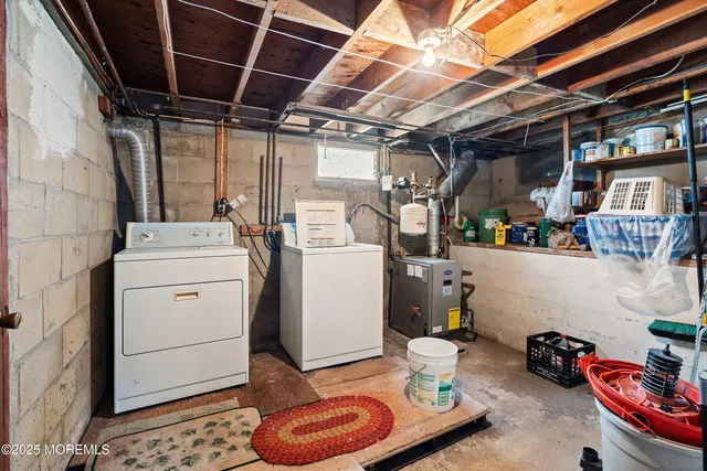 a utility room with a refrigerator and washer