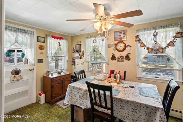 a view of a dining room with furniture and chandelier