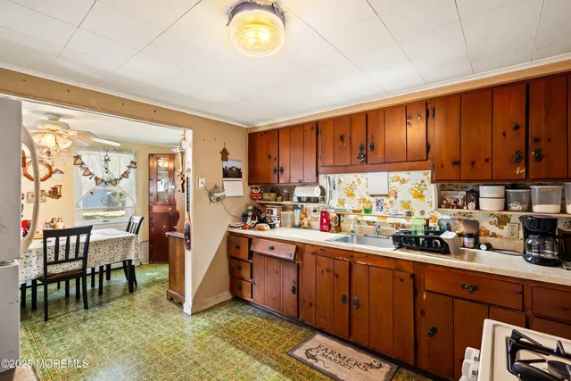 a kitchen with lots of counter top space and wooden floor