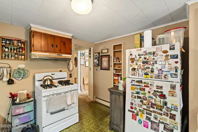 a kitchen with stainless steel appliances a refrigerator and a stove top oven