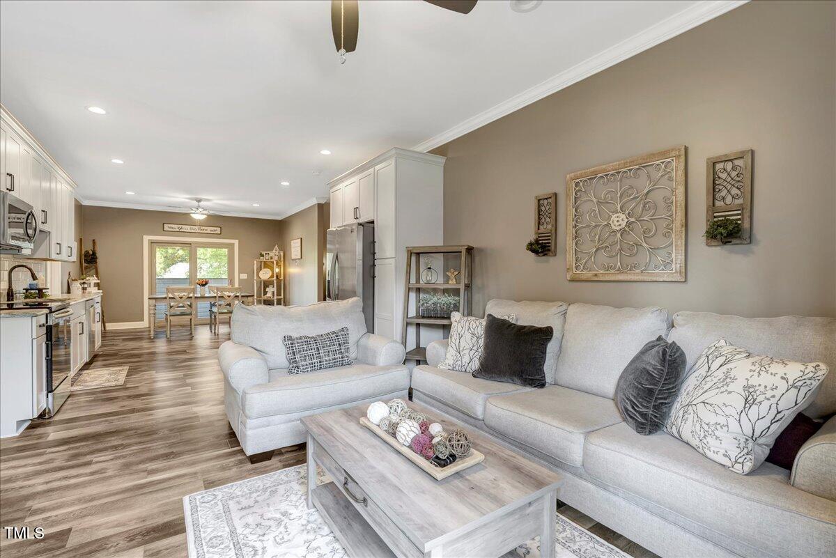 2258 Sanders Road Stem, NC 27581 - Photo 11 of 42 a living room with furniture and a wooden floor