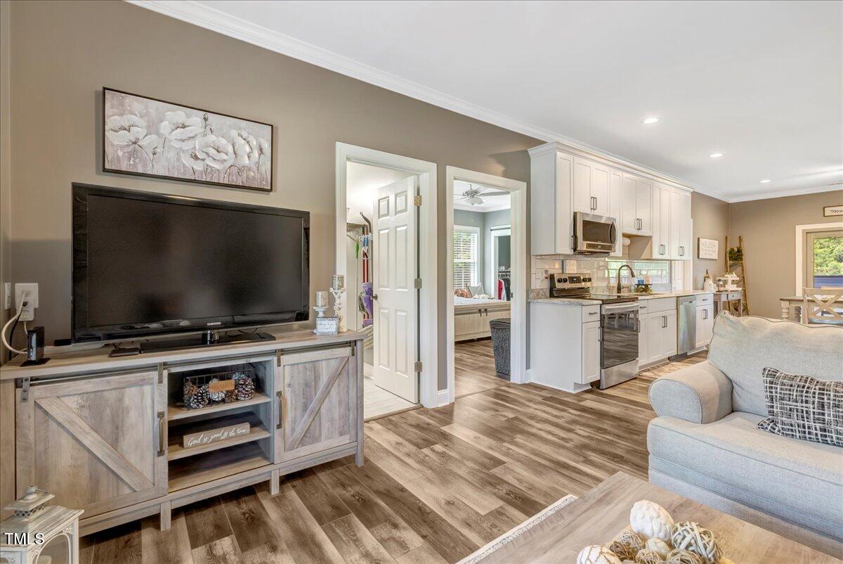 2258 Sanders Road Stem, NC 27581 - Photo 12 of 42 a living room with furniture and a flat screen tv