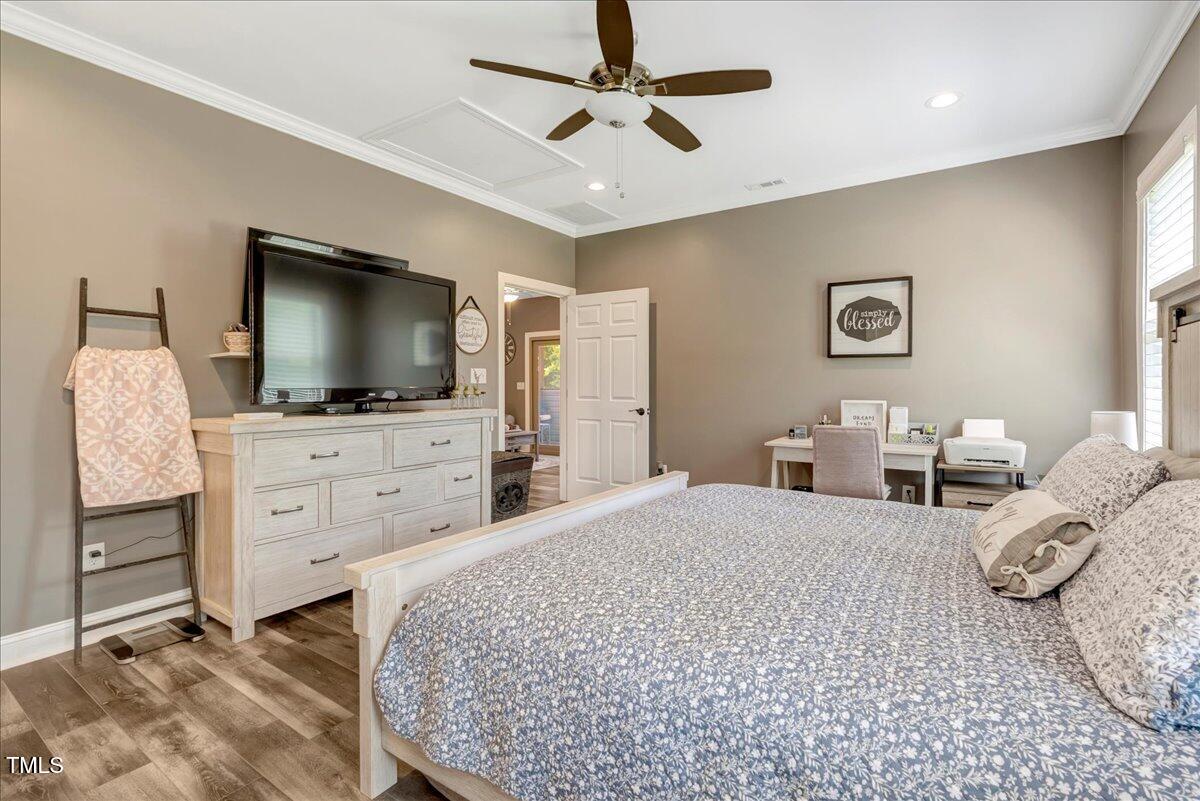 2258 Sanders Road Stem, NC 27581 - Photo 14 of 42 a bedroom with furniture and a flat screen tv