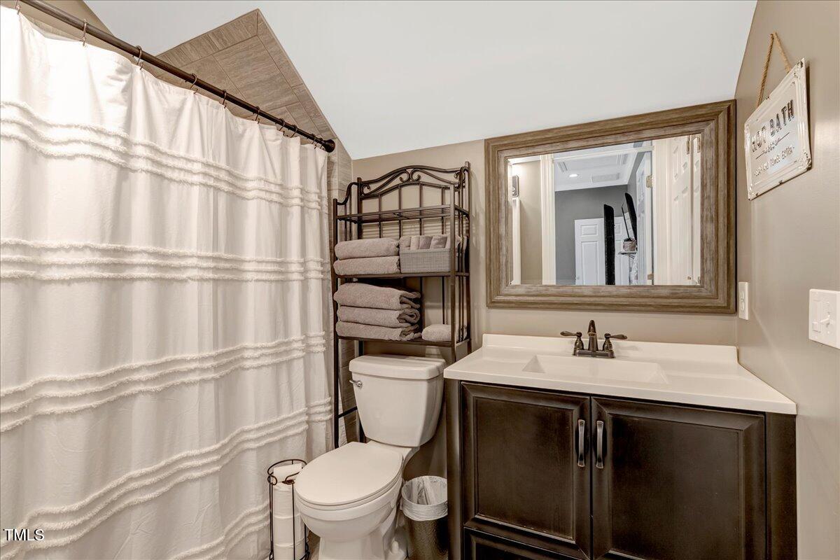 2258 Sanders Road Stem, NC 27581 - Photo 15 of 42 a bathroom with a sink toilet vanity and mirror