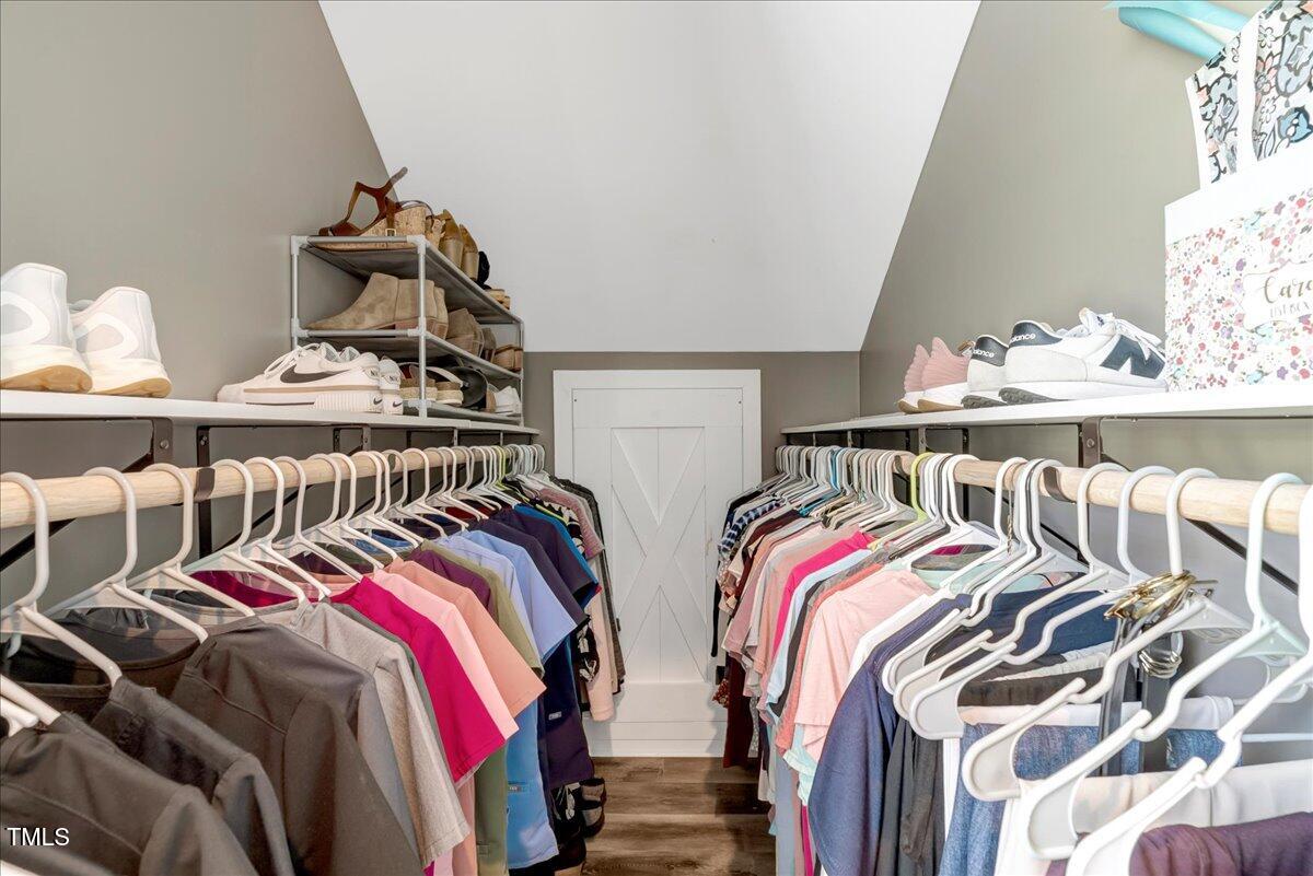 2258 Sanders Road Stem, NC 27581 - Photo 16 of 42 a view of walk in closet with clothes and shoes