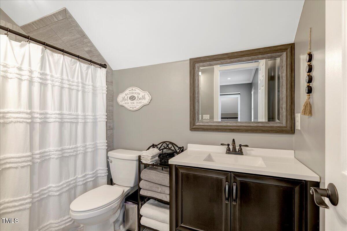 2258 Sanders Road Stem, NC 27581 - Photo 20 of 42 a bathroom with a sink a toilet and shower