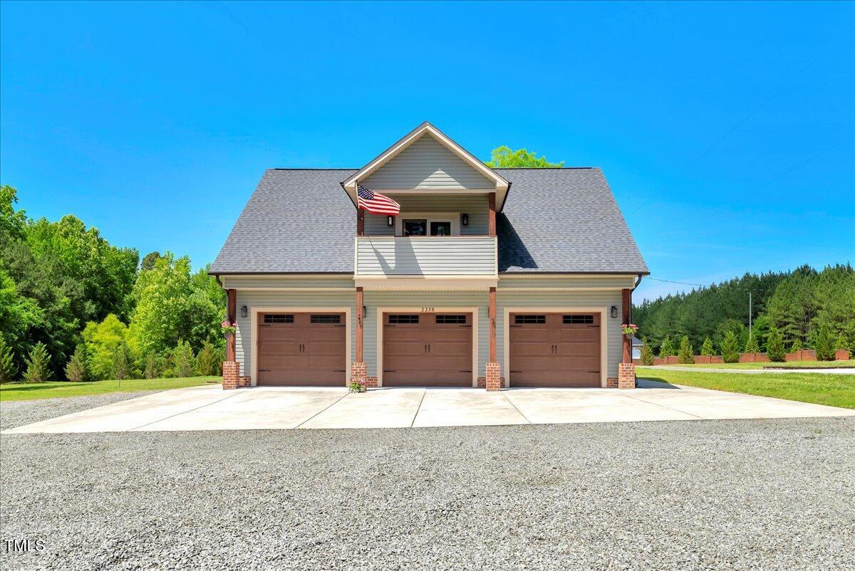 2258 Sanders Road Stem, NC 27581 - Photo 2 of 42 a front view of a house with a yard and garage