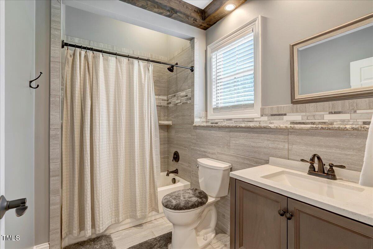 2258 Sanders Road Stem, NC 27581 - Photo 28 of 42 a bathroom with a sink toilet and shower