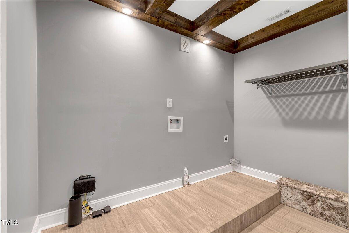 2258 Sanders Road Stem, NC 27581 - Photo 29 of 42 a bedroom with a bed and a wooden floor