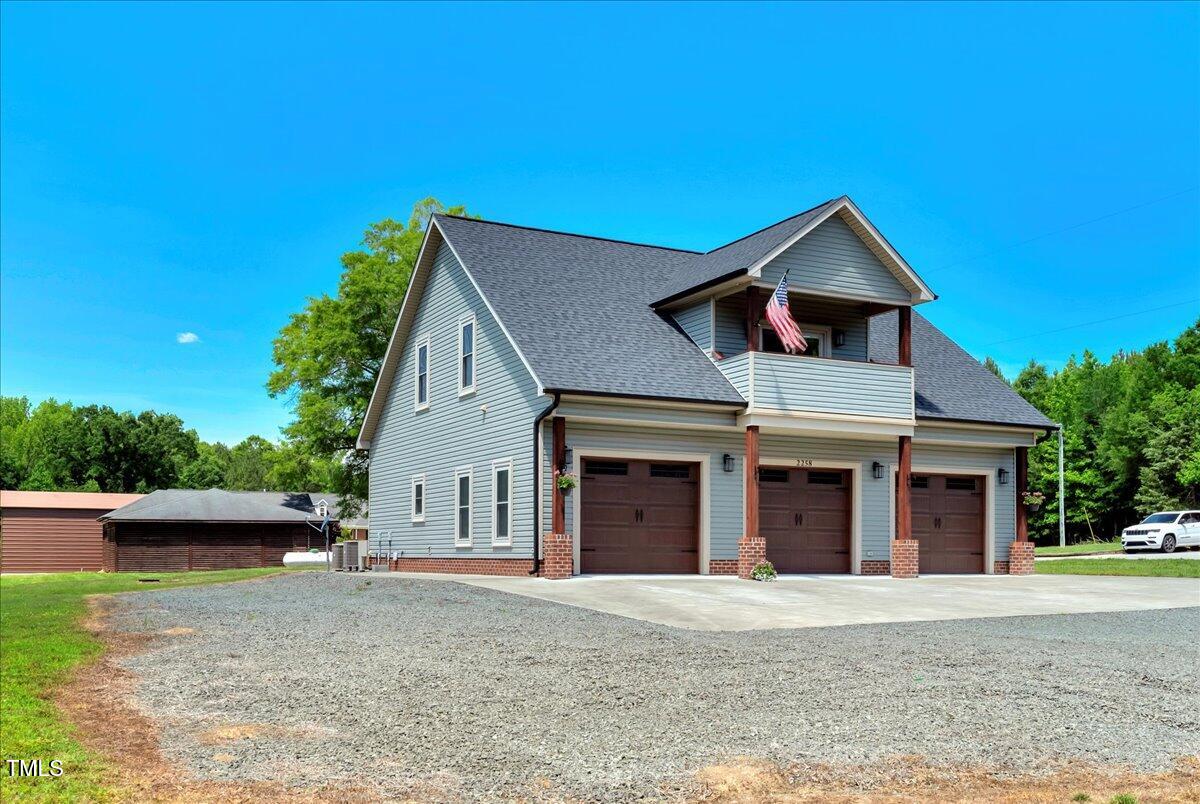 2258 Sanders Road Stem, NC 27581 - Photo 3 of 42 a front view of a house with a yard and garage