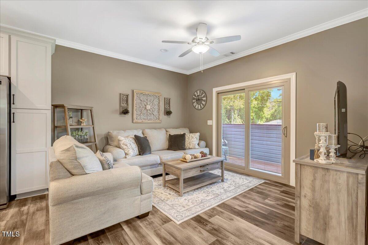 2258 Sanders Road Stem, NC 27581 - Photo 10 of 42 a living room with furniture and a flat screen tv