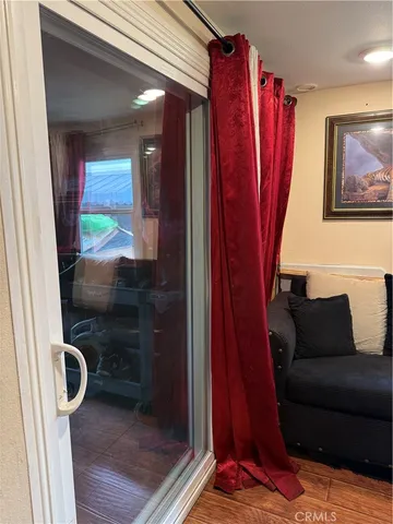 a living room with furniture a rug and a wooden floor