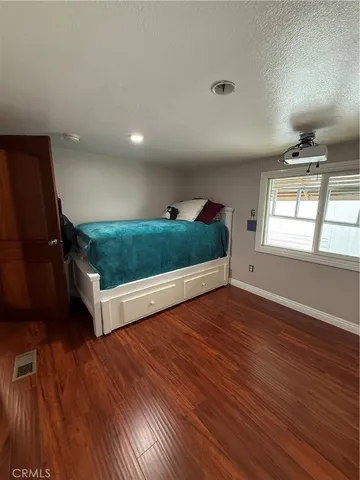 a living room with hard wood floors and a window