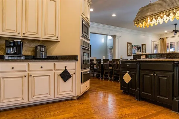 a kitchen with granite countertop a stove and a microwave