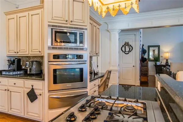 a living room kitchen with furniture and a large window