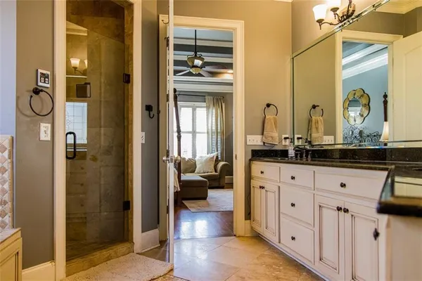 a bathroom with sinks granite countertop tub and a sink