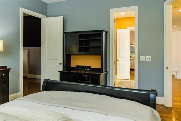 a bedroom with a bed and a dresser in it