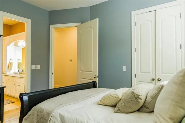 a bathroom with a granite countertop sink and a toilet