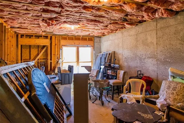 a kitchen with a stove a sink a dining table and chairs