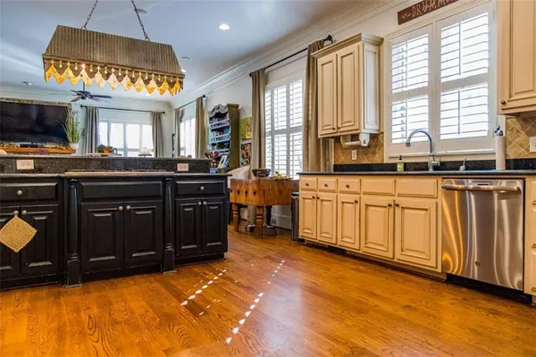 a kitchen with granite countertop stainless steel appliances a refrigerator and cabinets