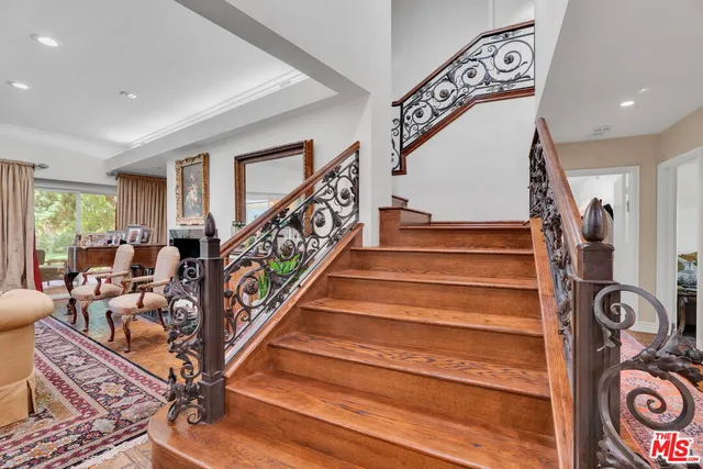 a backyard of a house with a garden and outdoor seating