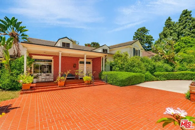 a view of a house with sitting area and garden