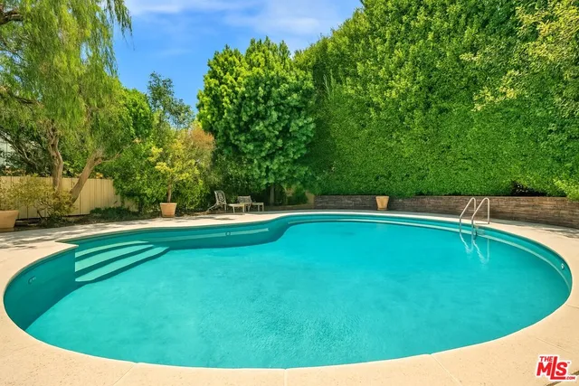 a view of a swimming pool with a yard