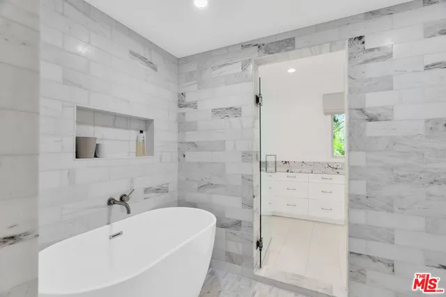 a white bath tub sitting next to a white sink
