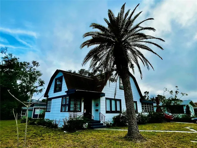 a front view of a house with swimming pool having outdoor seating