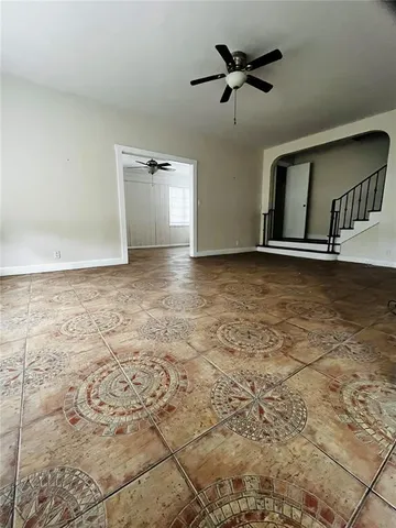 a view of hallway with a window and a refrigerator