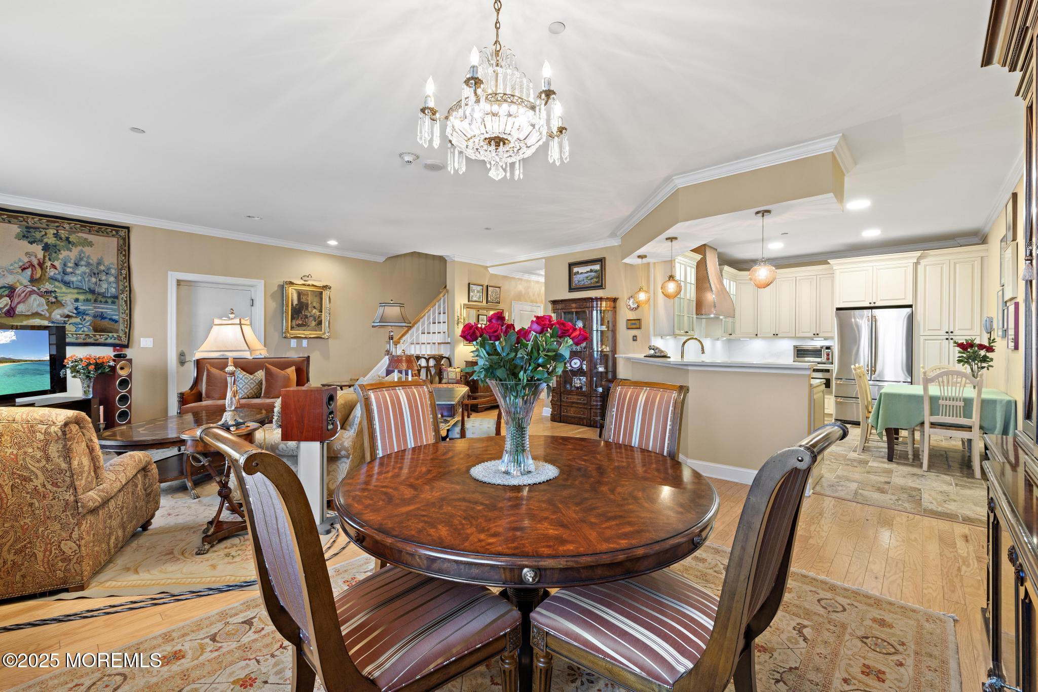 1501 Ocean Avenue, Unit 2112 Asbury Park, NJ 07712 - Photo 11 of 43 a dining room with furniture a chandelier and wooden floor