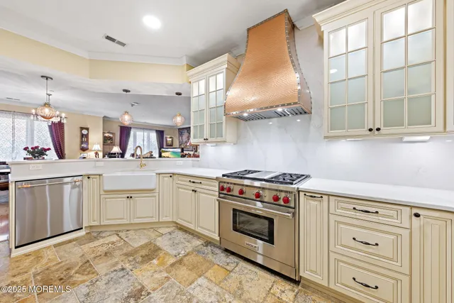 a kitchen with white cabinets and appliances