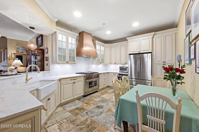 a kitchen with refrigerator and cabinets