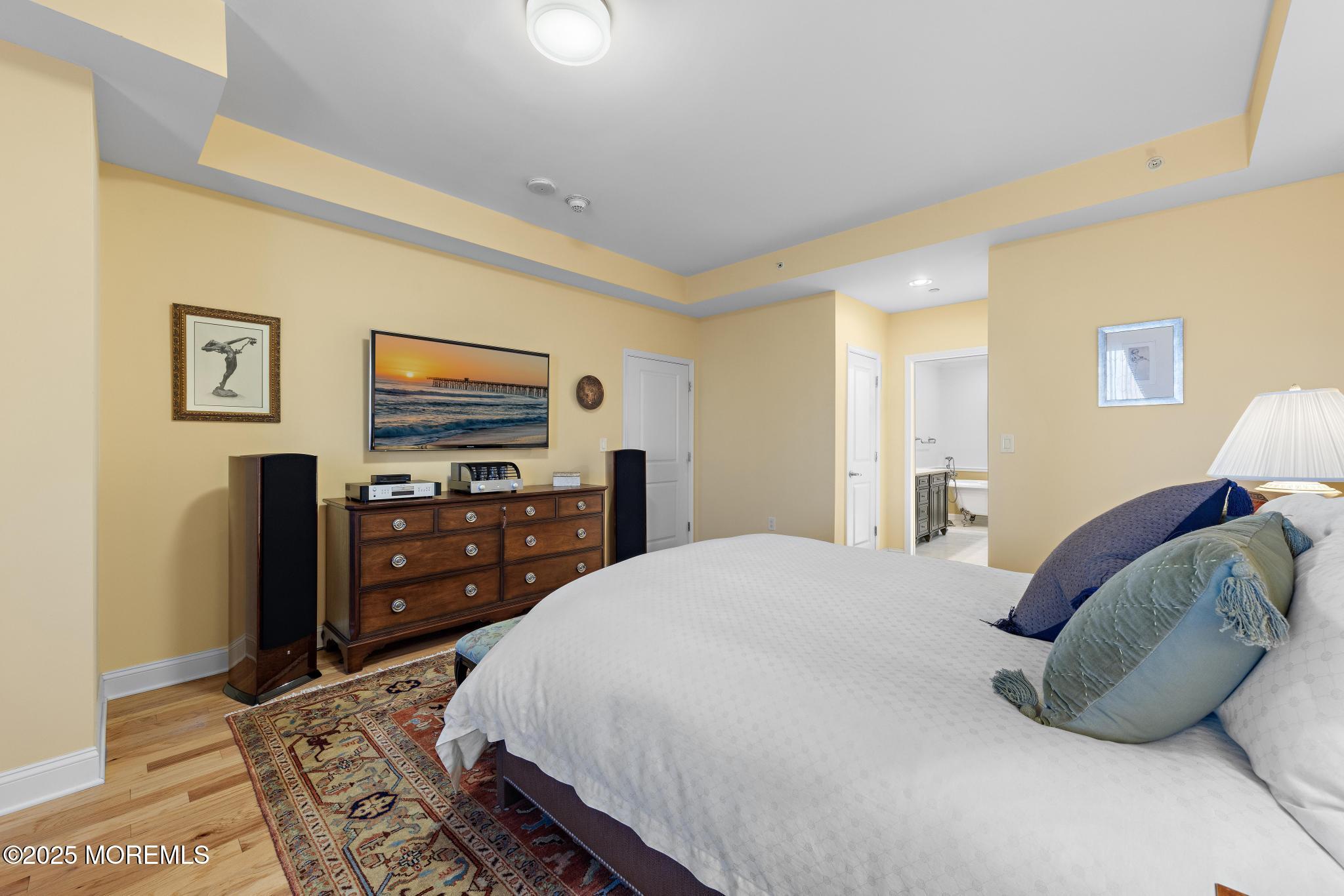 1501 Ocean Avenue, Unit 2112 Asbury Park, NJ 07712 - Photo 24 of 43 a bedroom with a bed and a flat screen tv