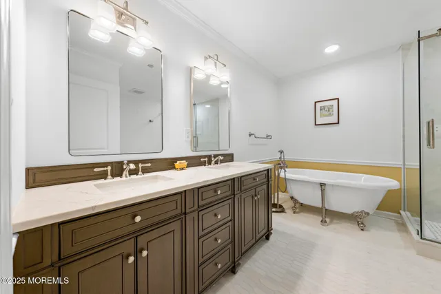 a bathroom with a double vanity sink mirror and bathtub