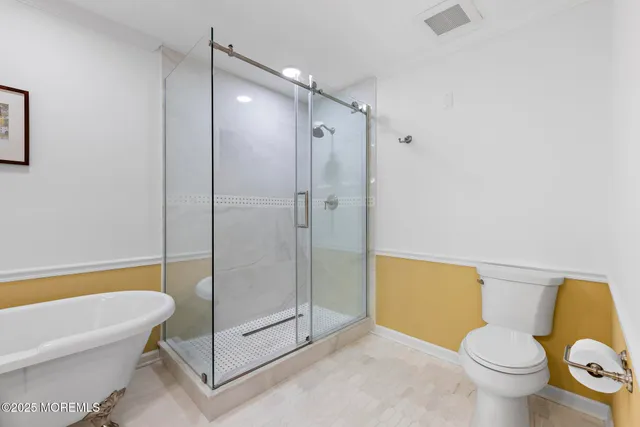a bathroom with a toilet and a bath tub