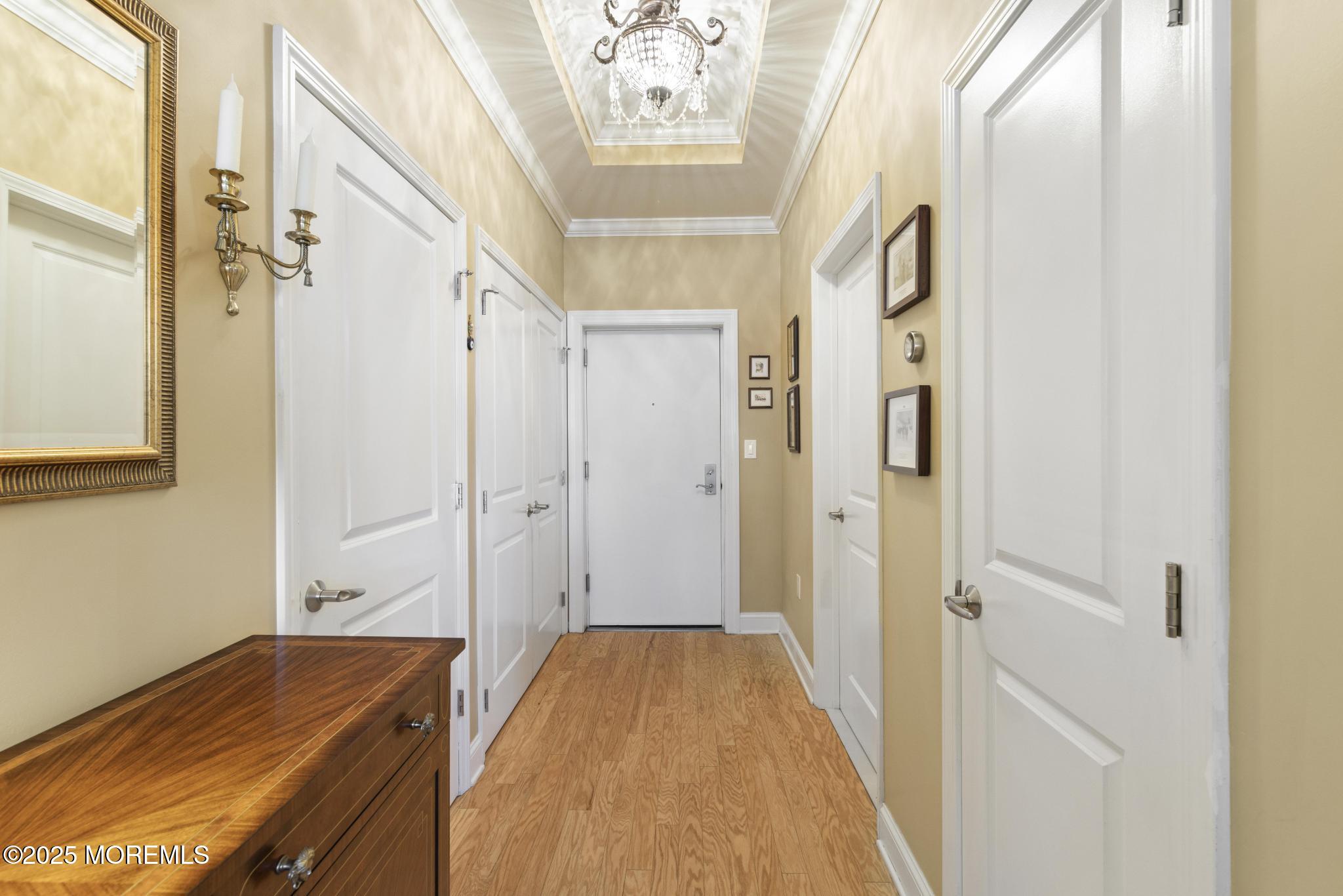 1501 Ocean Avenue, Unit 2112 Asbury Park, NJ 07712 - Photo 33 of 43 a view of a hallway with a chandelier