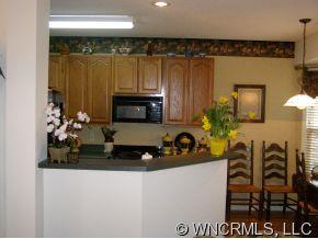 15 Livingston Farm Road Fletcher, NC 28732 - Photo 4 of 10 a kitchen with a refrigerator and a stove