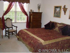 15 Livingston Farm Road Fletcher, NC 28732 - Photo 6 of 10 a bedroom with a bed a table and a large window