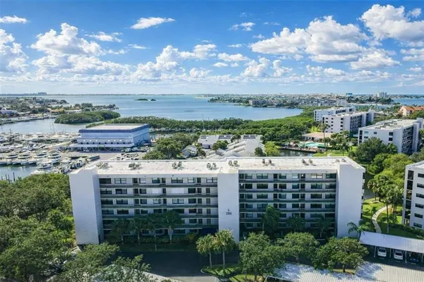 a front view of multi story residential apartment building with yard and green space