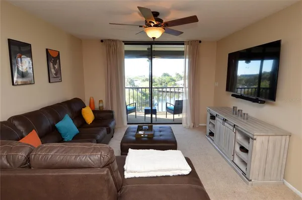 a bedroom with a bed and a flat tv screen on a dresser