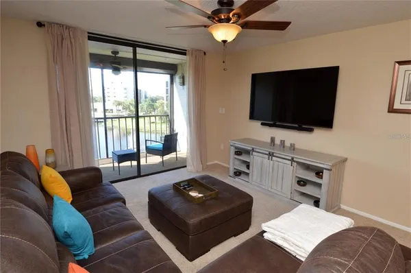 a view of a balcony with furniture and wooden floor