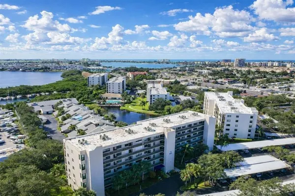 a view of an empty room with glass door and wooden floor