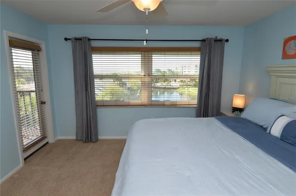 a view of a bedroom with a bed and wooden floor