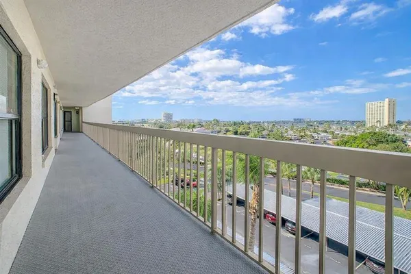 a kitchen with stainless steel appliances a stove top oven a sink a refrigerator white cabinets and wooden floor