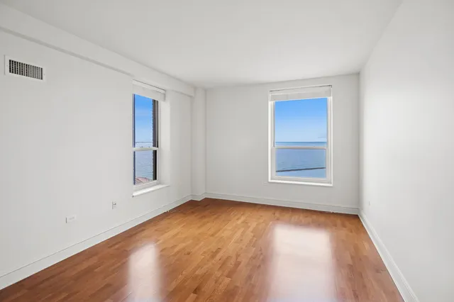 a bathroom with a toilet a sink a tub and mirror