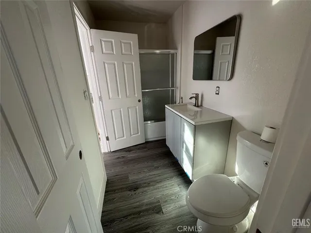 a bathroom with a sink toilet and mirror